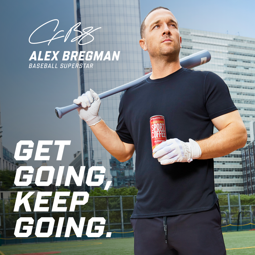 A baseball player holds a bat and a can of Salted Caramel Latte lactose free protein coffee on a city field, with the text: GET GOING, KEEP GOING. and ALEX BREGMAN, BASEBALL SUPERSTAR.