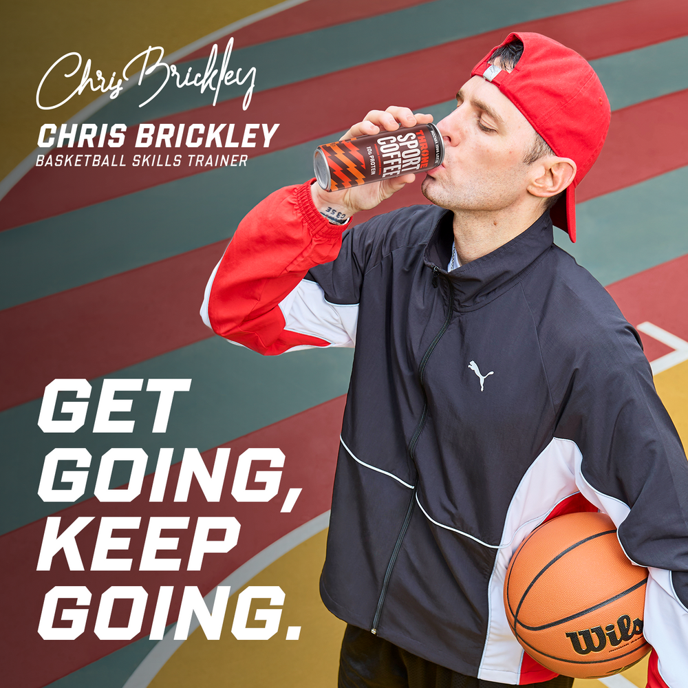A man in sportswear drinks from a can of Mocha Java Latte protein coffee while holding a basketball on a colorful court. The text says GET GOING, KEEP GOING. and Chris Brickley, Basketball Skills Trainer.