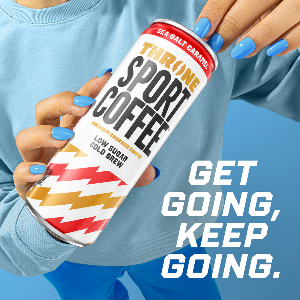 A person with blue nail polish holds a can of Sea Salt Caramel cold brew. Bold white text beside the can reads, GET GOING, KEEP GOING. The background and clothing feature various shades of blue.