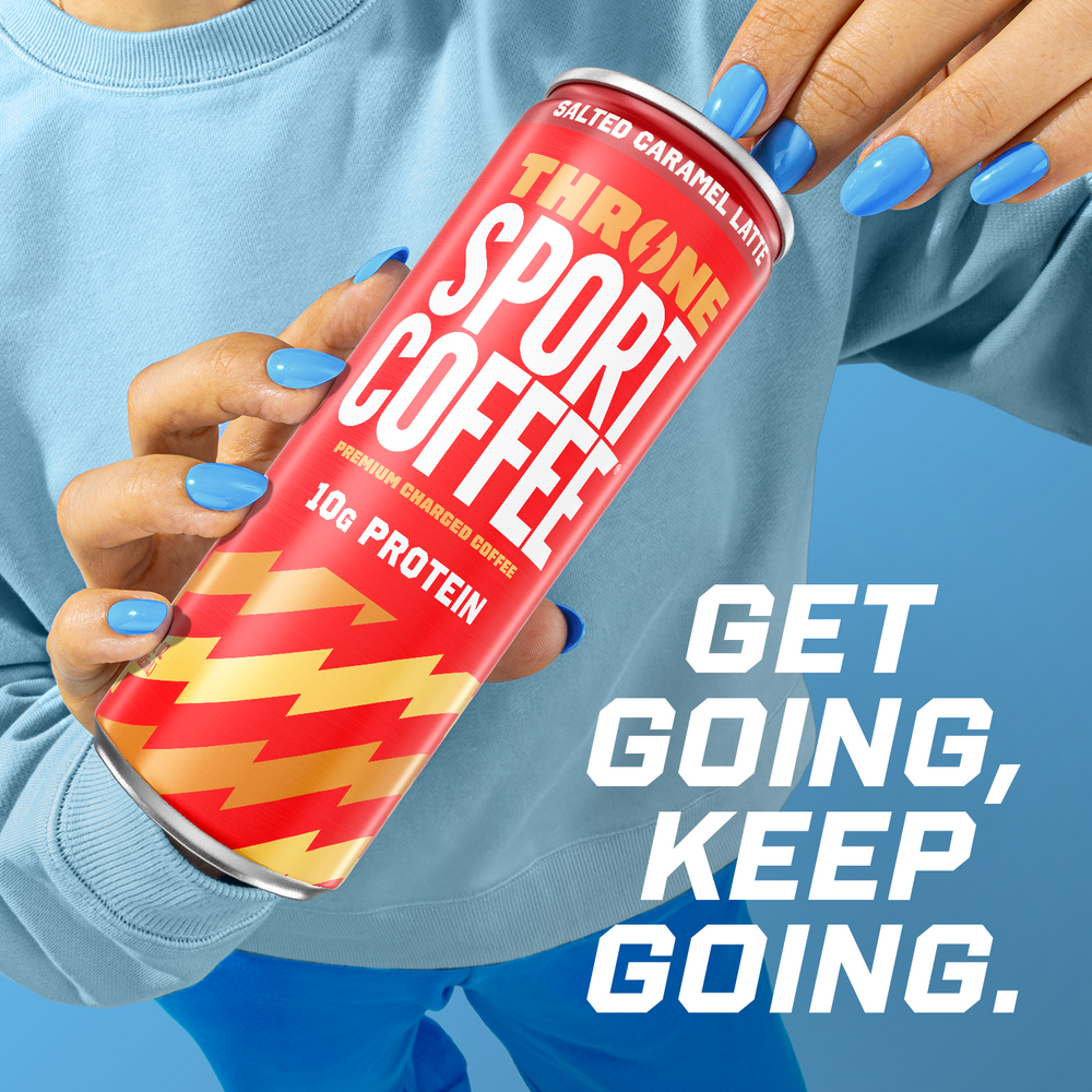 A person with blue nails holds a can of Salted Caramel Latte—made with lactose free milk. Text on the image reads, Get going, keep going. Both the background and their clothing are shades of blue.